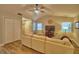 Bright living room with vaulted ceiling, fan, wood-look flooring, and a comfortable sectional sofa with natural light at 2835 Wingfoot Ct, Winter Haven, FL 33884