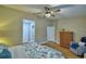 Cozy main bedroom with a ceiling fan, hardwood floors, and closet and bathroom access at 2835 Wingfoot Ct, Winter Haven, FL 33884