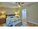 Comfortable main bedroom featuring an upholstered bench, ceiling fan, and ample closet space at 2835 Wingfoot Ct, Winter Haven, FL 33884