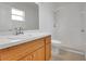 Bathroom with a white shower, wooden vanity with sink, and large mirror at 362 Lake Daisy Cir, Winter Haven, FL 33884