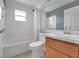Bathroom with tub/shower combination, white vanity and large mirror at 362 Lake Daisy Cir, Winter Haven, FL 33884