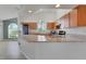 Bright kitchen with stainless steel appliances, granite countertops, wood cabinets and breakfast bar at 362 Lake Daisy Cir, Winter Haven, FL 33884