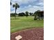 Backyard featuring a beautiful lawn and green trees on a bright day at 381 Troon Ct, Winter Haven, FL 33884