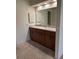Bathroom featuring a vanity with wood cabinets, a large mirror, and ample lighting at 381 Troon Ct, Winter Haven, FL 33884