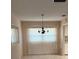 Bright dining area with large window and modern chandelier fixture at 381 Troon Ct, Winter Haven, FL 33884