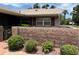 Cozy single-story home featuring a charming brick wall and mature landscaping at 381 Troon Ct, Winter Haven, FL 33884