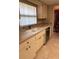 Functional kitchen with white cabinets, tile countertops, and stainless dishwasher at 381 Troon Ct, Winter Haven, FL 33884