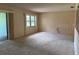 Inviting living room with plush carpeting and a sliding glass door at 381 Troon Ct, Winter Haven, FL 33884