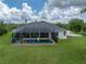 Aerial view of a home featuring an enclosed backyard pool at 3985 Mammoth Grove Rd, Lake Wales, FL 33898