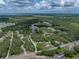 Expansive aerial view capturing the property amidst sprawling greenery, roads, and waterways at 3985 Mammoth Grove Rd, Lake Wales, FL 33898
