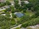 Aerial view of a well-maintained property featuring a private pool, lush greenery, and a charming residence at 3985 Mammoth Grove Rd, Lake Wales, FL 33898
