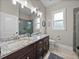 Bathroom featuring a double vanity with granite countertop, window, and framed shower at 3985 Mammoth Grove Rd, Lake Wales, FL 33898