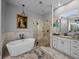 Bright bathroom showcasing a soaking tub, glass-enclosed shower, and double vanity at 3985 Mammoth Grove Rd, Lake Wales, FL 33898