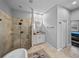 Bathroom with stone tiled shower, double vanity, and glass shower doors at 3985 Mammoth Grove Rd, Lake Wales, FL 33898