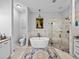 Elegant bathroom featuring a freestanding tub, glass shower, and stylish tile work at 3985 Mammoth Grove Rd, Lake Wales, FL 33898