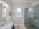Bright bathroom showcasing a granite-topped vanity, toilet, window, and glass-enclosed shower at 3985 Mammoth Grove Rd, Lake Wales, FL 33898