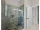 Modern shower with glass door, stone pebble floor, and tiled walls plus a built-in niche at 3985 Mammoth Grove Rd, Lake Wales, FL 33898