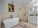Bright bathroom showcasing a soaking tub, glass-enclosed shower, and double vanity at 3985 Mammoth Grove Rd, Lake Wales, FL 33898