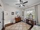 Bright bedroom with a ceiling fan, dresser with vanity, window, and neutral walls at 3985 Mammoth Grove Rd, Lake Wales, FL 33898