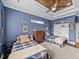 Charming bedroom with twin beds, ceiling fan and wood detail, and playful sports decor at 3985 Mammoth Grove Rd, Lake Wales, FL 33898