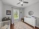 Bedroom with a crib, dresser, window and neutral decor, perfect for a serene space at 3985 Mammoth Grove Rd, Lake Wales, FL 33898