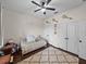 Charming bedroom with a cozy daybed, ceiling fan, ample storage, and hardwood floors at 3985 Mammoth Grove Rd, Lake Wales, FL 33898