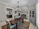 Open dining room with stylish light fixture, neutral colors, and easy access to kitchen and living room at 3985 Mammoth Grove Rd, Lake Wales, FL 33898
