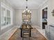 Formal dining room features large window, decorative chandelier, and neutral paint colors at 3985 Mammoth Grove Rd, Lake Wales, FL 33898