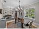 Spacious dining room with stylish light fixture, neutral colors, and lots of natural light at 3985 Mammoth Grove Rd, Lake Wales, FL 33898