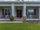 Inviting front porch featuring stately columns and comfortable seating, perfect for relaxing at 3985 Mammoth Grove Rd, Lake Wales, FL 33898