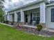 Inviting front porch with rocking chairs and classic columns, adding charm to the home's exterior at 3985 Mammoth Grove Rd, Lake Wales, FL 33898