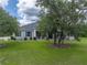 Home exterior with front lawn, trees, and walkway at 3985 Mammoth Grove Rd, Lake Wales, FL 33898