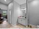 Hallway leading to a bathroom with tile floors and view into bedroom at 3985 Mammoth Grove Rd, Lake Wales, FL 33898
