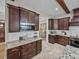 Modern kitchen with stainless steel appliances, dark wood cabinets and granite countertops at 3985 Mammoth Grove Rd, Lake Wales, FL 33898
