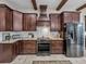 Gourmet kitchen with dark wood cabinetry, stainless steel appliances and granite countertops at 3985 Mammoth Grove Rd, Lake Wales, FL 33898