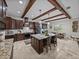 Open kitchen boasts stainless steel appliances, wooden support beams and granite countertops at 3985 Mammoth Grove Rd, Lake Wales, FL 33898