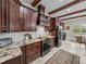 Open kitchen features wooden support beams, dark wood cabinets and stainless steel appliances at 3985 Mammoth Grove Rd, Lake Wales, FL 33898