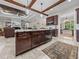 Modern kitchen with a center island, stainless steel appliances, granite countertops, and dark wood accents at 3985 Mammoth Grove Rd, Lake Wales, FL 33898