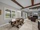 Bright living area featuring a rustic picnic table and wooden support beams at 3985 Mammoth Grove Rd, Lake Wales, FL 33898