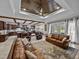 Spacious living room with wood ceiling, beam accents, leather furniture and access to the backyard at 3985 Mammoth Grove Rd, Lake Wales, FL 33898