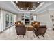 Cozy living room with fireplace, built-in shelving, and large windows offering lots of natural light at 3985 Mammoth Grove Rd, Lake Wales, FL 33898