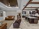 Bright open-concept living space with coffered ceiling, granite island, and comfortable seating arrangement at 3985 Mammoth Grove Rd, Lake Wales, FL 33898