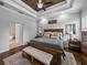 Comfortable main bedroom featuring a decorative wood ceiling, neutral color palette and ensuite bathroom access at 3985 Mammoth Grove Rd, Lake Wales, FL 33898