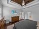 Comfortable main bedroom featuring a decorative wood ceiling, neutral color palette and a TV at 3985 Mammoth Grove Rd, Lake Wales, FL 33898