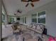 Spacious covered patio featuring a seating and dining area, ceiling fans, and a view of the outdoor living area at 3985 Mammoth Grove Rd, Lake Wales, FL 33898