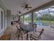 Spacious covered patio area with dining and seating area, ceiling fans, and a view of the pool at 3985 Mammoth Grove Rd, Lake Wales, FL 33898