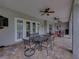 Covered patio featuring ceiling fans, a dining area, a seating area, and a view of the outdoor pool at 3985 Mammoth Grove Rd, Lake Wales, FL 33898