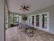 Covered patio with a ceiling fan, dining table, and screened views of the yard at 3985 Mammoth Grove Rd, Lake Wales, FL 33898
