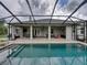 Outdoor pool with a covered patio featuring dining and lounge areas at 3985 Mammoth Grove Rd, Lake Wales, FL 33898