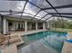 Screened-in pool with ample seating, perfect for outdoor relaxation and entertainment at 3985 Mammoth Grove Rd, Lake Wales, FL 33898